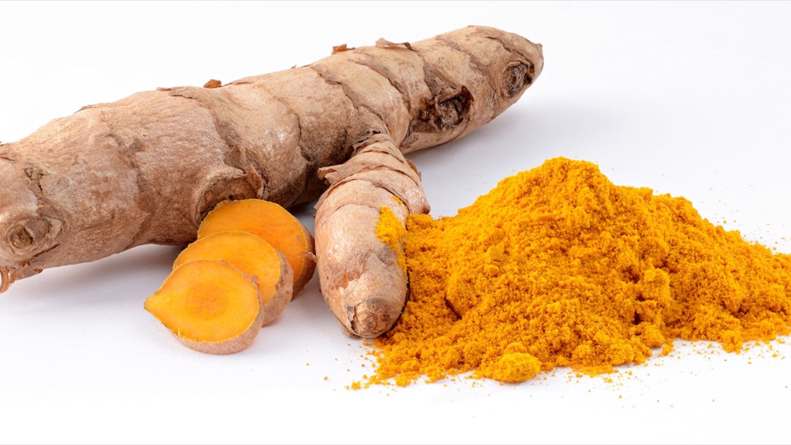 Fresh ginger and bright orange turmeric rhizomes freshly lifted