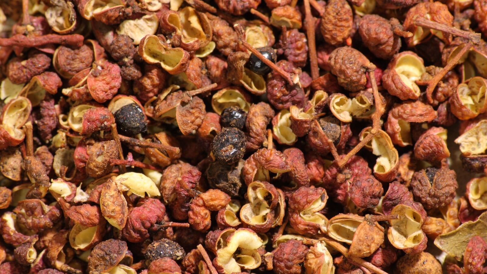 Reddish-brown split husks of dried Sichuan pepper