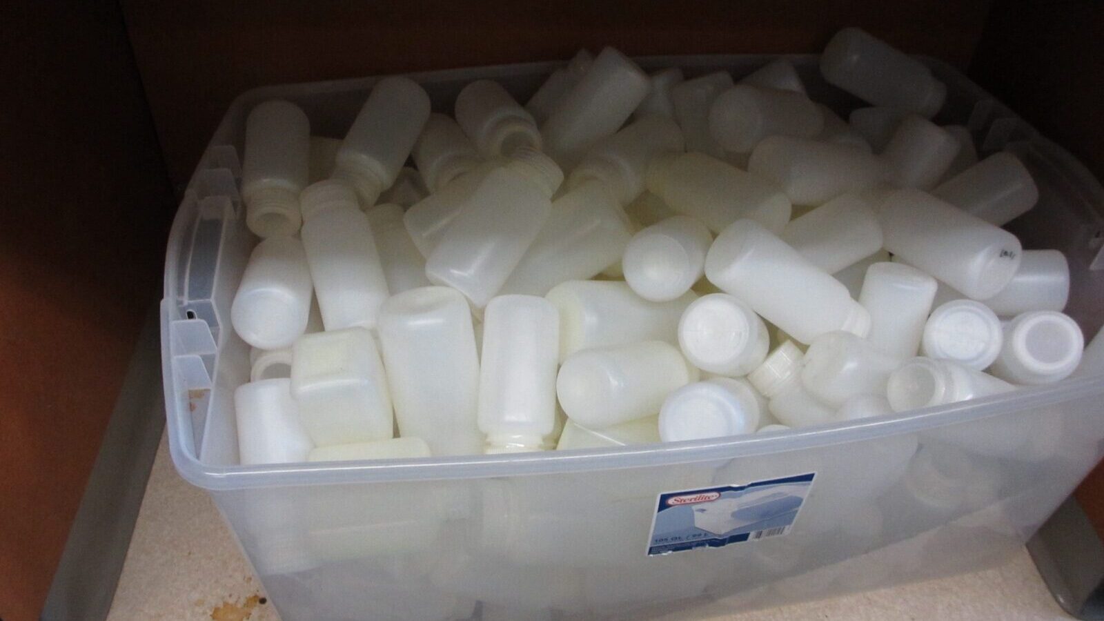 Water samples in test bottles beside a field testing kit and record sheet